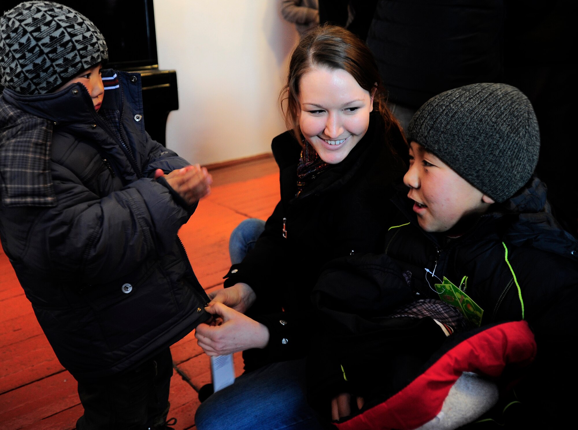 Staff Sgt. Elise Pavlak, a humanitarian assistance representative with the Theater Security Cooperation division at the Transit Center at Manas, helps two boys get fitted for new winter coats at an Operation Warm and Dry distribution in Balykchy City, Kyrgyzstan, Jan. 15, 2012. With two simultaneous distributions, more than 1,000 coats and 200 blankets were given to Kyrgyz Republic citizens in need in Balykchy, becoming the largest distribution event since the program's creation in 2009.  Pavlak is deployed to the TCM from RAF Alconbury, England.
(U.S. Air Force photo/Staff Sgt. Angela Ruiz)
