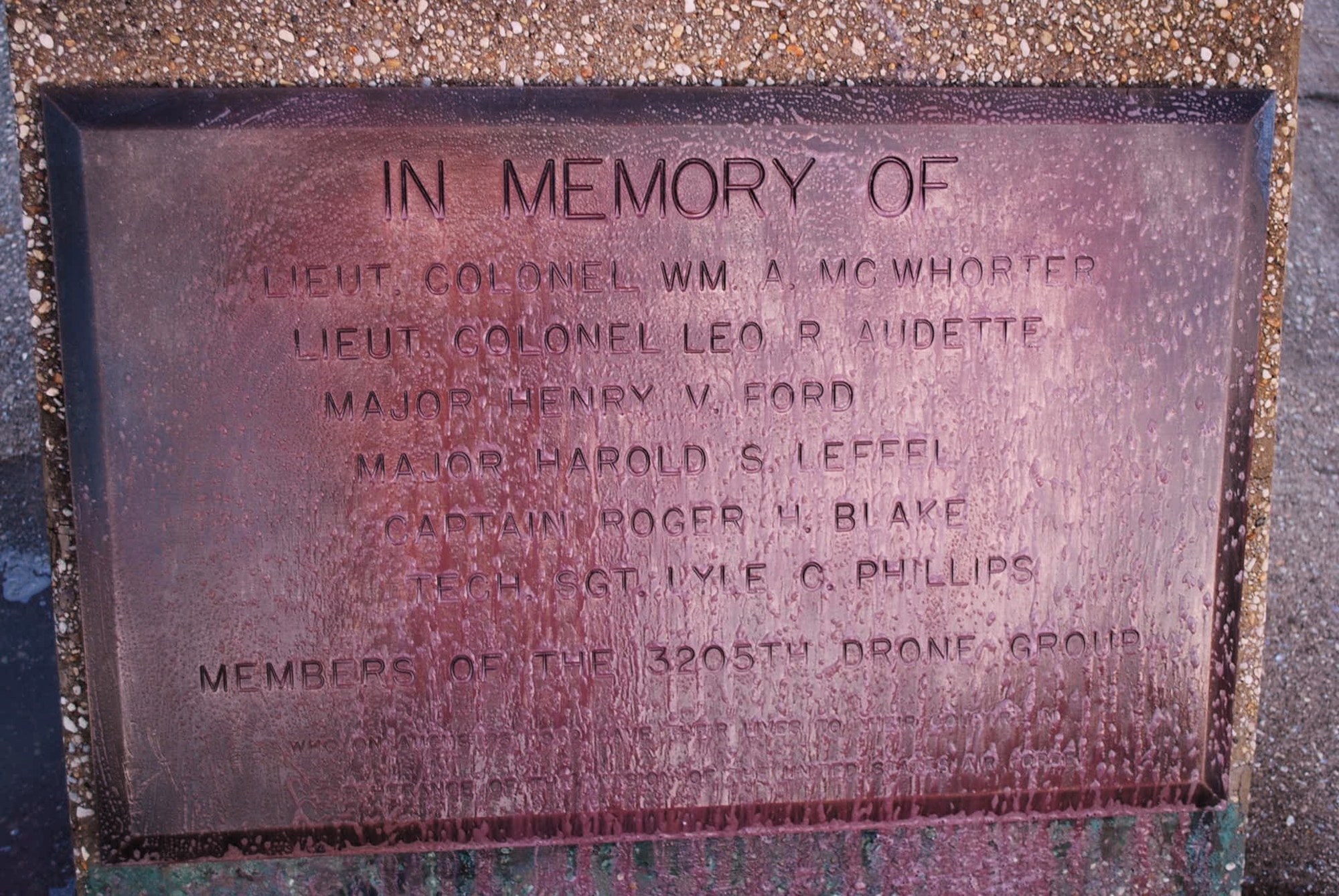 A brass memorial plaque at Duke Field, Fla., shows the effects of years of exposure to the elements.  A group of volunteers from the 919th Force Support Squadron and Top 3 Association recently donated their time to restore the historical plaque and improve landscaping in the base’s centrally located memorial area.  (Courtesy photo) 