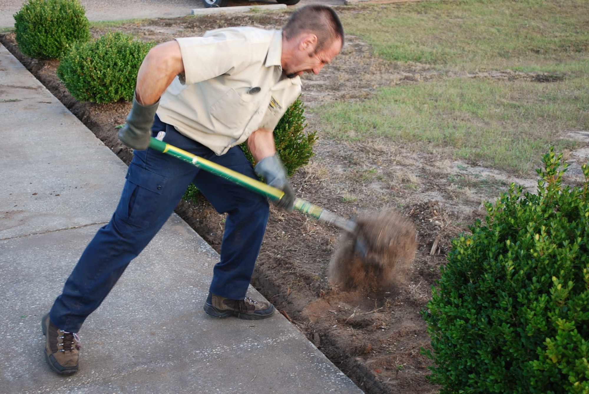 Tony Peppey, a civilian employee from the 919th Force Support Squadron, shovels dirt during a recent volunteer project at Duke Field, Fla.   Peppey was among a group of FSS and Top 3 Association volunteers who worked to beautify the base’s centrally located memorial area with a host of landscaping and maintenance projects.  (Courtesy photo) 