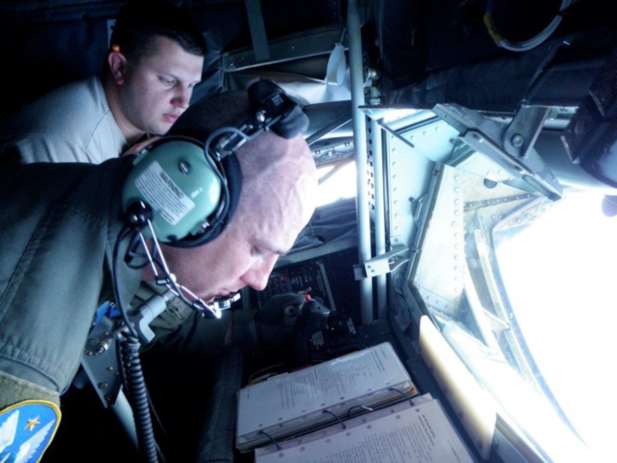 Senior Master Sgt. Ray Lewis, a refueling boom operator assigned to the 18th Air Refueling Squadron, 931st Air Refueling Group, McConnell Air Force Base, Kan., reviews his checklist during a refueling flight.  Lewis has been a boom operator on the KC-135 Stratotanker for more than twenty years.  (Photo courtesy of Ray Lewis)