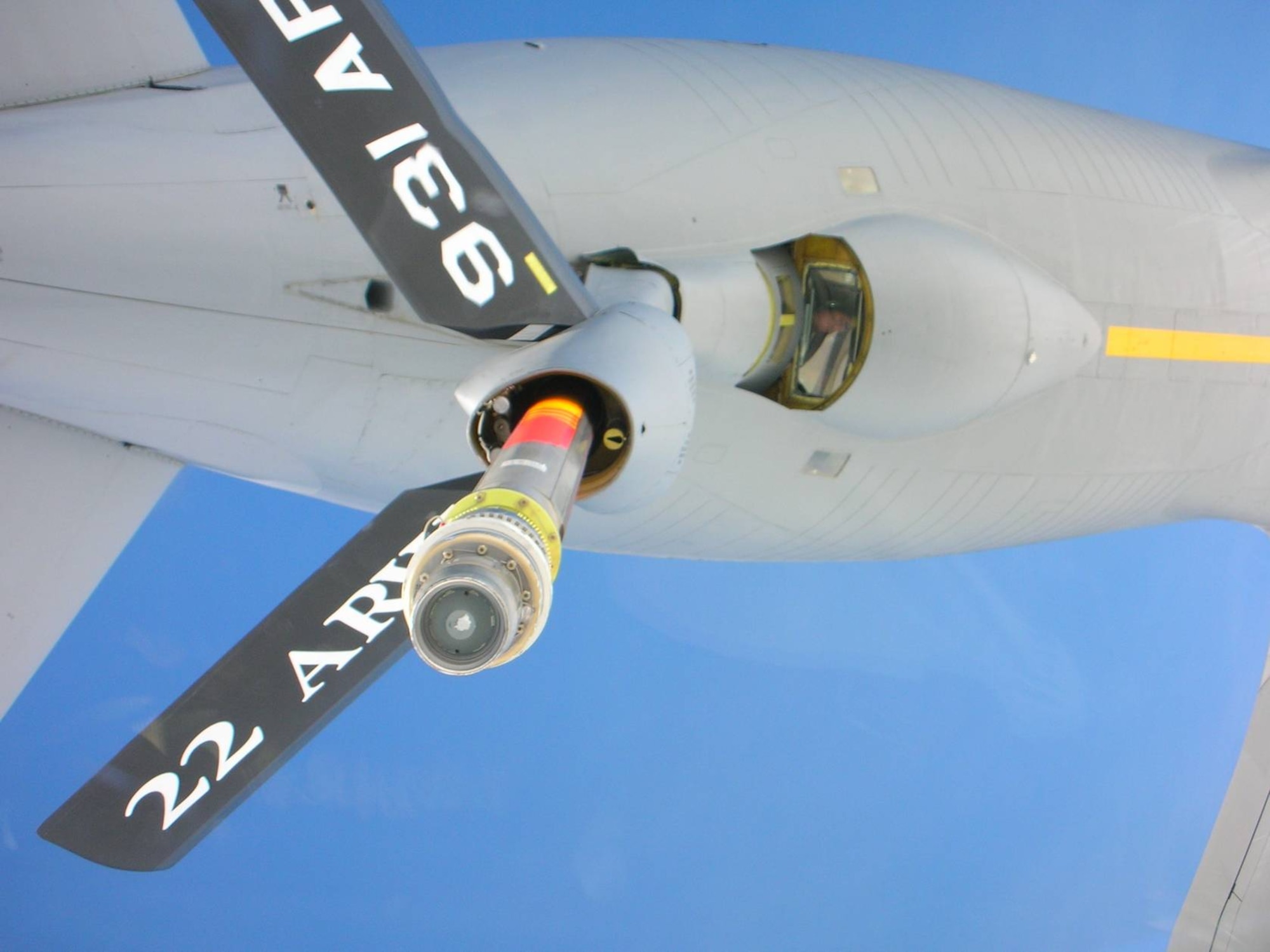 Senior Master Sgt. Ray Lewis, a refueling boom operator assigned to the 18th Air Refueling Squadron, 931st Air Refueling Group, McConnell Air Force Base, Kan., peers down at the receiving aircraft from the boom pod of a KC-135 Stratotanker during a refueling flight.  Lewis has been a boom operator on the KC-135 Stratotanker for more than twenty years.  (Photo courtesy of Ray Lewis)