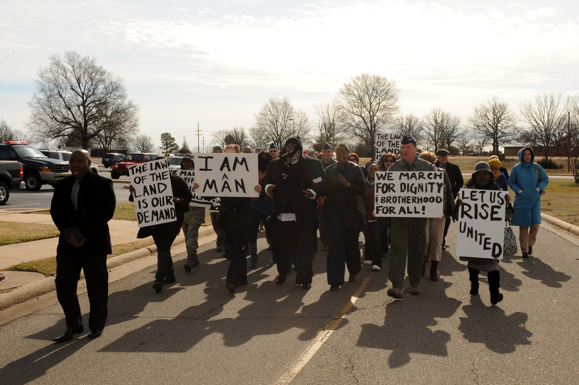 Team Little Rock Members participate in the Dr. Martin Luther King Jr. remembrance walk outside the base theater Jan. 13, 2012, at Little Rock Air Force Base, Ark. The walk was done in commemoration of the famous protests and marches orchestrated by King during his time as a civil rights activist.  (U.S. Air Force Photo by Airman 1st Rusty Frank)  