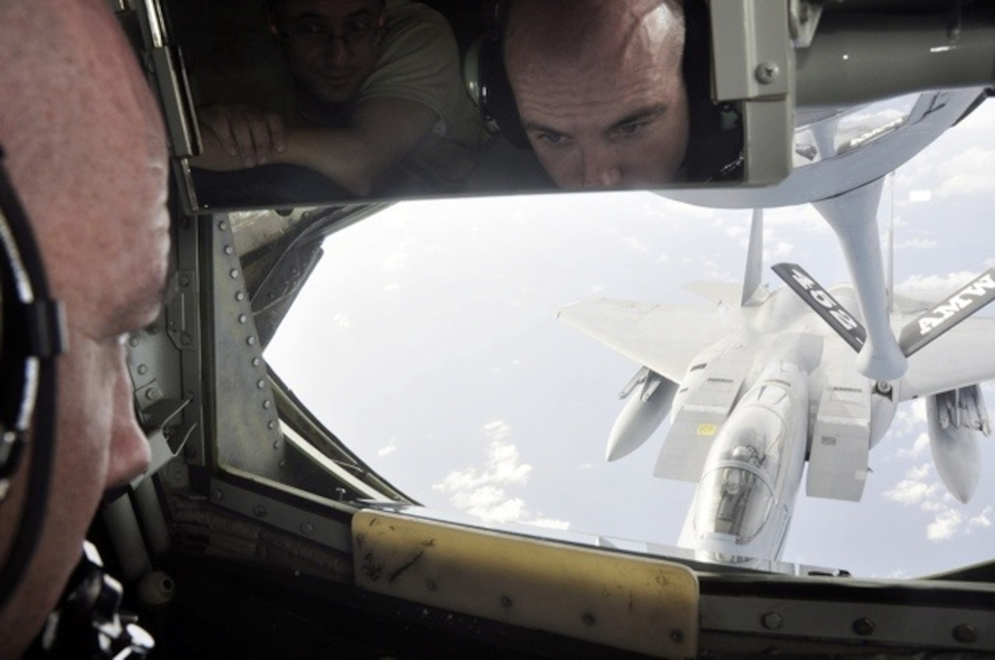 Senior Master Sgt. Ray Lewis, a refueling boom operator assigned to the 18th Air Refueling Squadron, 931st Air Refueling Group, McConnell Air Force Base, Kan., refuels an F-15 fighter during a flight over Hawaii.  Lewis has been a boom operator on the KC-135 Stratotanker for more than twenty years.  (Photo courtesy of Ray Lewis)