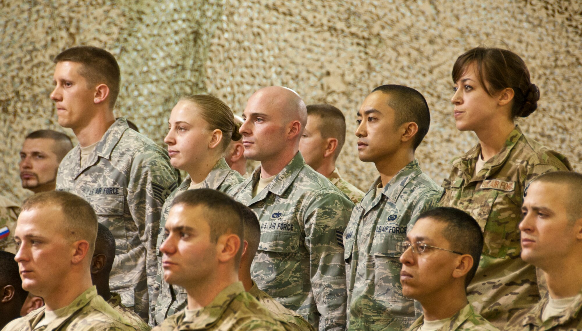 KANDAHAR AIRFIELD, Afghanistan -- The five Air Force inductees wait to recite the Air Force NCO charge during the Joint NCO Induction ceremony at the MWR Fest Tent at Kandahar Airfield, Afghanistan Jan. 14, 2012. During the ceremony, NCOs from the U.S. Army and Air Force as well as Slovakian Army were inducted into the NCO corps. (U.S. Air Force photo by Staff Sgt. David Carbajal)