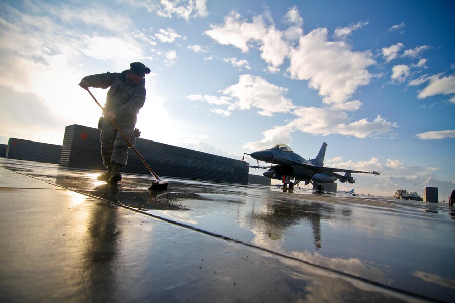 U.S. Air Force Master Sgt. Chris Skierski sweeps the flight line for foreign objects and debris at Bagram Air Field, Afghanistan on Jan 15, 2012.  Skierski is an F-16C Fighting Falcon engine mechanic assigned to the 455th Expeditionary Aircraft Maintenance Squadron, and is deployed from the 177th Fighter Wing, New Jersey Air National Guard.   U.S. Air Force photo/Tech. Sgt. Matt Hecht