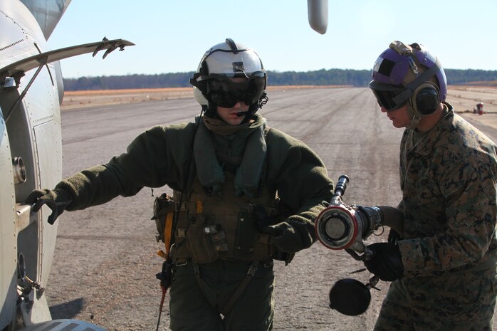 FORT PICKET, Va. - (Right) Lance Cpl. Nicholas Verdisco, a bulk fuel specialist with Marine Medium Tiltrotor Squadron VMM-261 (Reinforced), 24th Marine Expeditionary Unit, prepares to fuel an MV-22 Osprey with a Helicopter Expedient Refueling System, here, Jan. 14, 2012. The Marines refueled the aircraft to support a simulated airfield seizure at Farmville Municipal Airport as part of the 24th MEU's Realistic Urban Training (RUT) exercise scheduled Jan. 5-20. RUT focuses on conducting off-base missions near the town of Farmville, Va., to prepare for the various operations they may conduct during their upcoming deployment. (Official USMC photo by Sgt. Richard Blumenstein) 