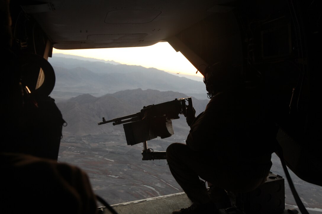 Cpl. Timothy Dockum serves as an aerial observer watching the Afghan landscape for threats behind a .50-caliber machinegun of an MV-22B Osprey, Jan. 17. Dockum, a native of McMinnville, Tenn., deployed with Marine Medium Tiltrotor Squadron 365 which is replacing Marine Tiltrotor Squadron 162.