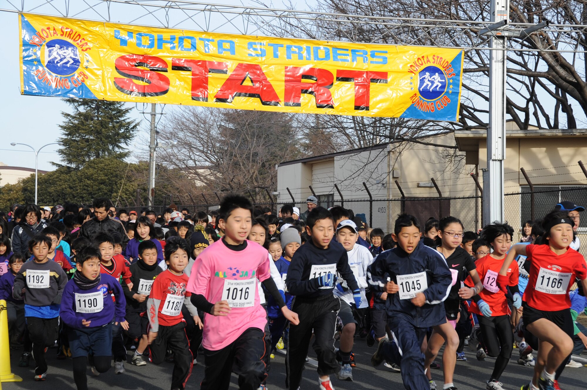 YOKOTA AIR BASE, Japan -- Children take off from the starting line for the 2K Kids Run held at Yokota Air Base, Japan, Jan. 15, 2012. First place for the boys was Shion Hotta, who finished with a time of 5:46. The first place runner for the girls was Ronoa Kitoh, who finished with a time of 6:25. (U.S. Air Force photo/Naoko Kurokui)
