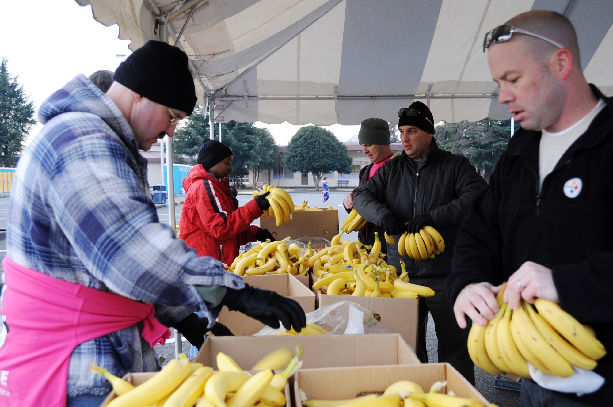 YOKOTA AIR BASE, Japan -- Members of the 1st Sergeants Council and Top 3 group, prepare bananas to give out to runners at the finish line at the 31st Annual Frostbite Run held at Yokota Air Base, Japan, Jan. 15, 2012. More than 10,000 runners participated in the event. (U.S. Air Force photo/Naoko Kurokui)