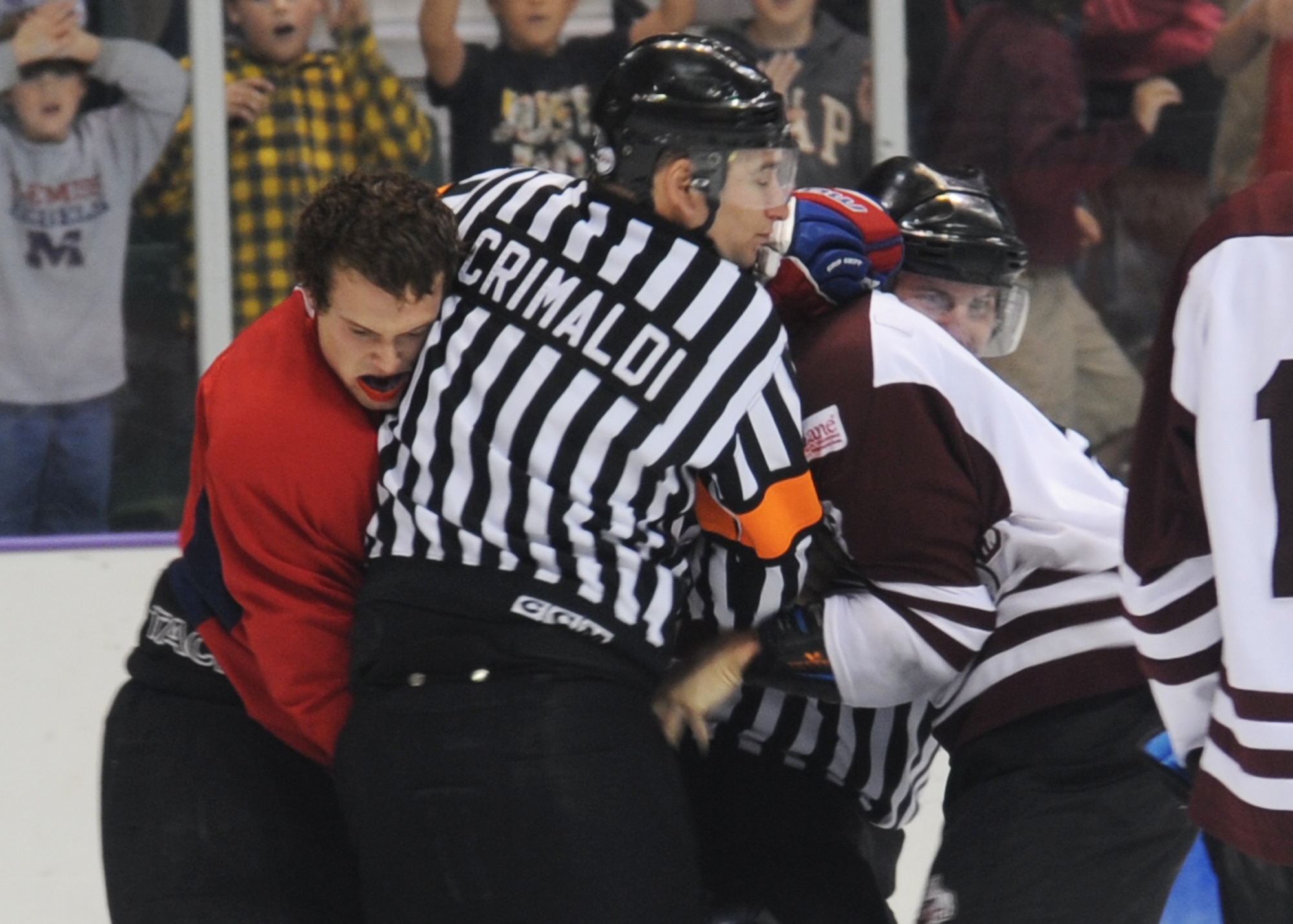 Airman 1st Class Crimaldi breaks up a fight 4 Nov. during a hockey game.  Crimaldi is a part-time hockey referee and works in the finance department on Columbus Air Force Base.  (U.S. Air Force photo/Airman 1st Class Chase Hedrick)
