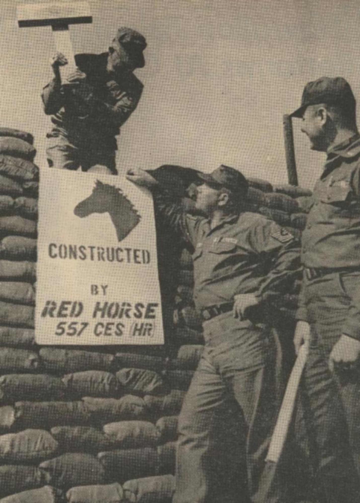 THIS ONE’S OURS --Joining military personnel and Korean nationals at Osan AB, Red Horse personnel assisted in building sand bag bunkers in scattered areas of the base. Each Red Horse bunker has a sign such as the one displayed by, from left to right, MSgt. John E. Hopkins, MSgt. William M. Castor and 1st Lt. James E. Hoskins.
