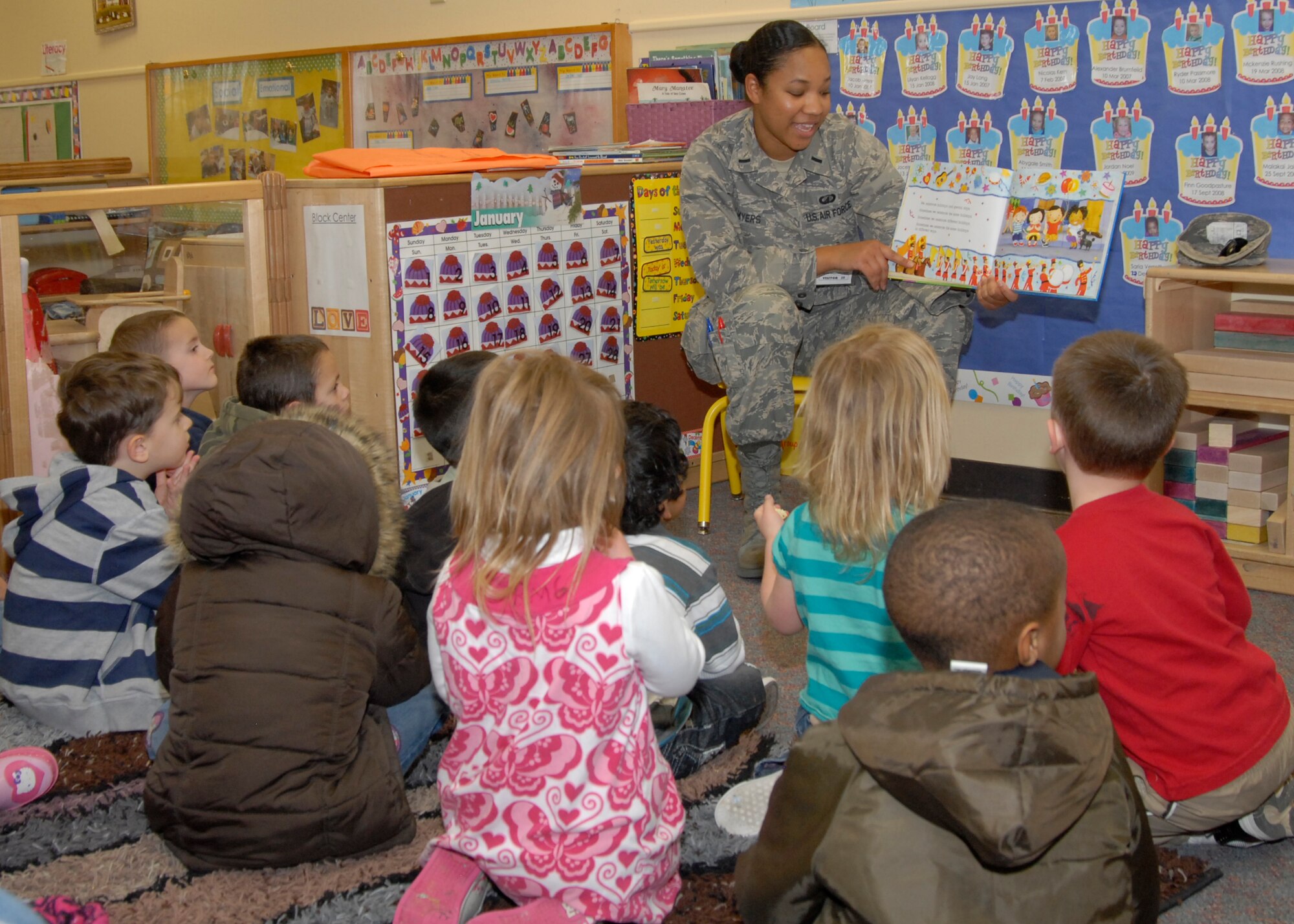 1st Lt. Tieu Myers reads to preschoolers at the Child Development Center here on Wednesday, Jan. 11 in honor of the Martin Luther King Jr. observance. The stories educated children on the legacy of Martin Luther King Jr., as well as tolerance, acceptance, and unity. (U.S. Air Force Photo by Laura Mowry)