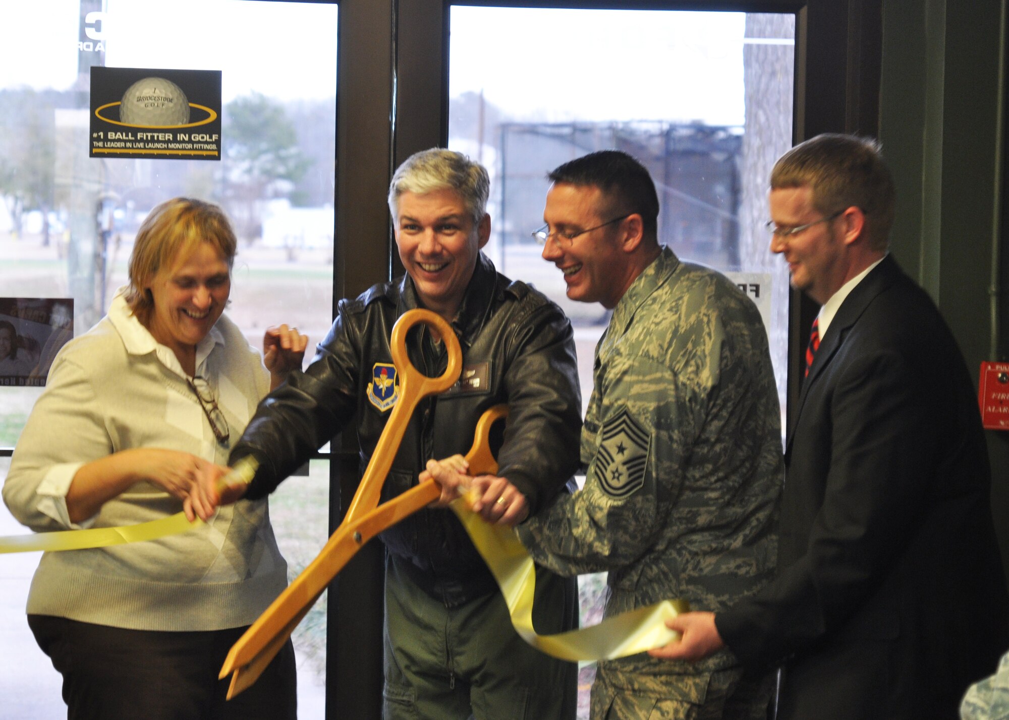 Pam Whickam, Golf Course Manager, Col. Barre Seguin, 14th Flying Training Wing commander, 14th Flying Training Wing Command Chief Master Sgt. Vance Kondon, and Nicholas Roos, Chief of Community Services, participate in the ribbon-cutting ceremony for the newly renovated Golf Course Pro Shop.  The Pro Shop received its first upgrade since 1994 including new snack bar equipment, a new bar, new carpet and many other updated amenities. (U.S. Air Force photo/Airman 1st Class Charles Dickens)