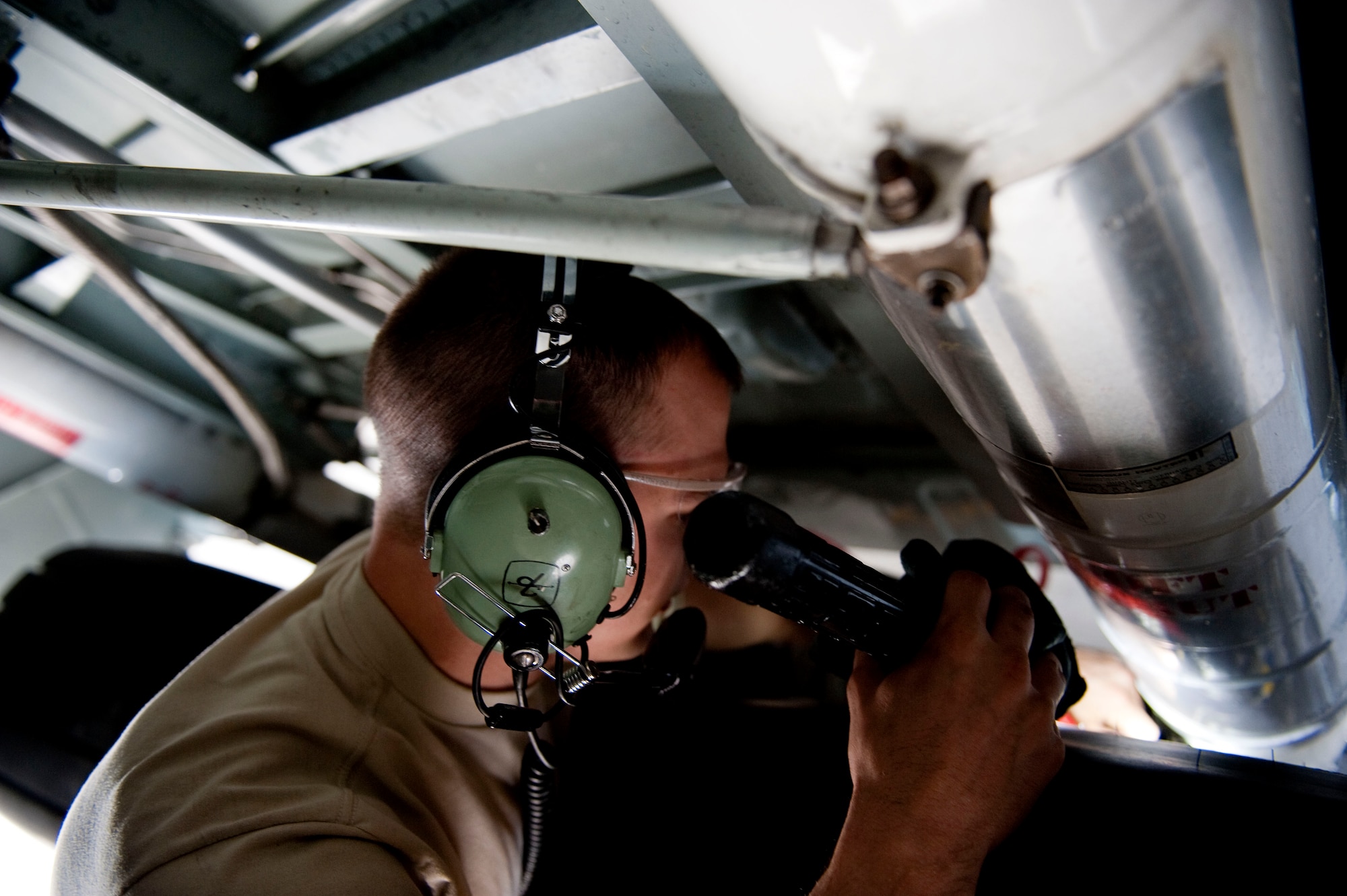 U.S. Air Force Senior Airman Sean McGuirk, a hydraulics technician for 4th Aircraft Maintenance unit, checks wires behind the tire of an AC-130U Spooky on Hurlburt Field, Fla., Jan. 12, 2012. A 4th AMU Airman provides maintenance support for the AC-130U Spooky gunships at home and down range. (U.S. Air Force photo/Airman 1st Class Christopher Williams)(Released)

