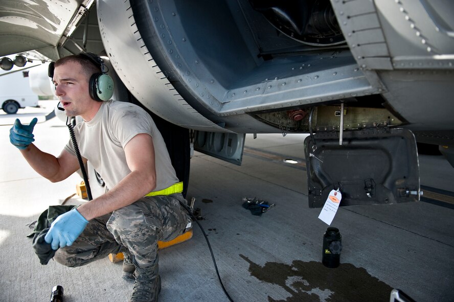 U.S. Air Force Senior Airman Sean McGuirk, a hydraulics technician for 4th Aircraft Maintenance Unit, interacts with fellow Airman during aircraft maintenance on an AC-130U Spooky on Hurlburt Field, Fla., Jan. 12, 2012. The 4th AMU maintainers perform on-equipment flightline tasks; pre- and post-flight serviceability inspections; and aircraft system repair and minor modifications helping to ensure aircraft return safely. (U.S. Air Force photo/Airman 1st Class Christopher Williams)(Released)

