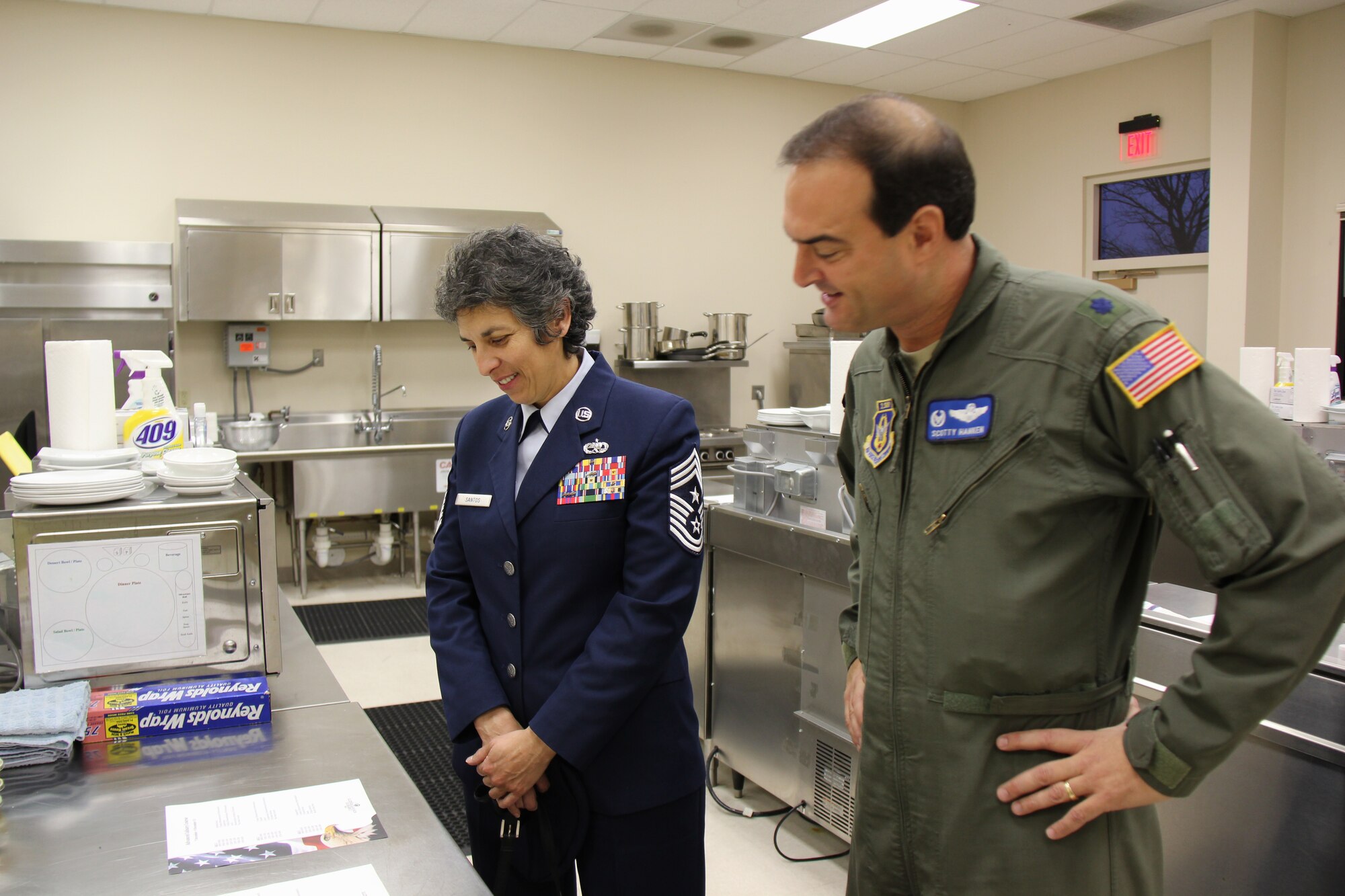 932nd Airlift Wing Command Chief Master Sgt. Sandra Santos meets with 932nd Operations Group, Detachment 1 commander, Lt. Col. Scotty Hanken, out at Andrews Air Force Base.  He gave an overview of the kitchen facility and offices throughout the building to the chief and wing commander.  He oversees flight attendants who help make the wing's missions successful.  (U.S. Air Force photo/Maj. Stan Paregien).
