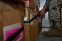 Staff Sgt. Cody Wyatt, 28th Logistics Readiness Squadron Mobility Readiness Spares Package and aircraft parts store supervisor, straps down boxes in an MRSP at Ellsworth Air Force Base, S.D., Jan. 10, 2012. Securing the packages ensures critical aircraft parts arrive safely to support B-1s participating in the Red Flag combat training exercise at Nellis AFB, Nev. (U.S. Air Force photo by Airman 1st Class Kate Thornton/Released)