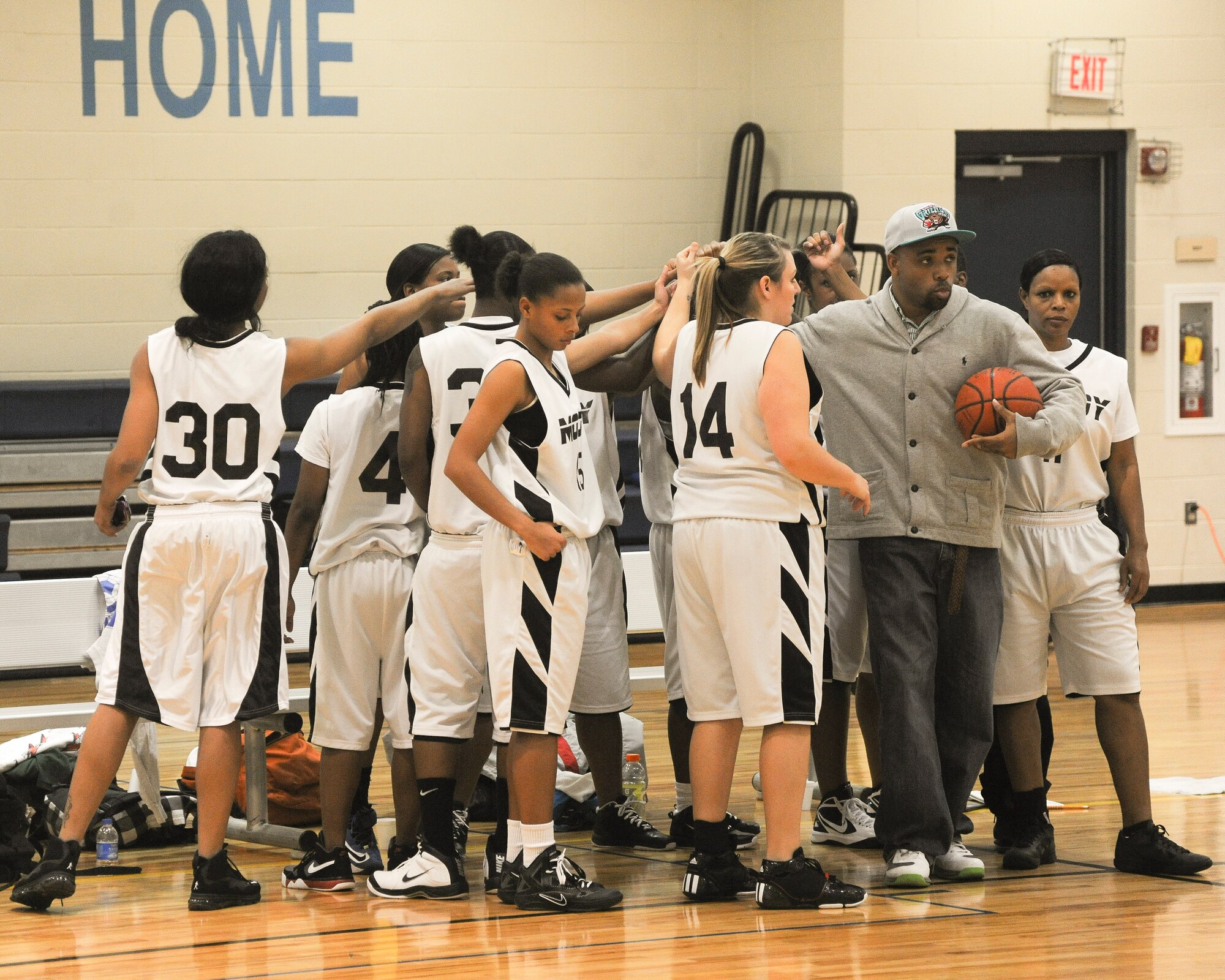 The Moody Air Force Base Lady Flying Tigers take a timeout to discuss a game plan and slow the momentum of Robins Air Force Base during a varsity basketball game at Moody Air Force Base, Ga., Jan. 14, 2012. Moody called the time out to set a game plan to avoid a second half collapse and snap Robins’ 7-point run. (U.S. Air Force photo by Airman 1st Class Paul Francis/Released)  
