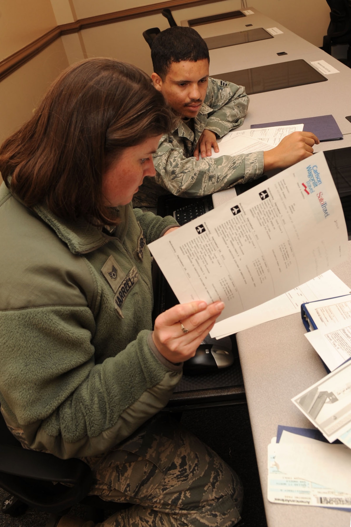 U. S. Air Force Staff Sgt. Tracy Harrell, 30th Intelligence Squadron imagery analyst, receives in-processing assistance from Senior Airman Fernando Pereira, 633rd Comptroller Squadron military pay technician, at Langley Air Force Base Va., Jan. 10, 2012. The 633rd CPTS Finance Customer Service Office uses the Permanent Change of Station In-Processing System, PIPS, which allows personnel to file their own PCS vouchers from start to finish without a middleman. (U.S. Air Force photo by Staff Sgt. Jeff Nevison/Released)