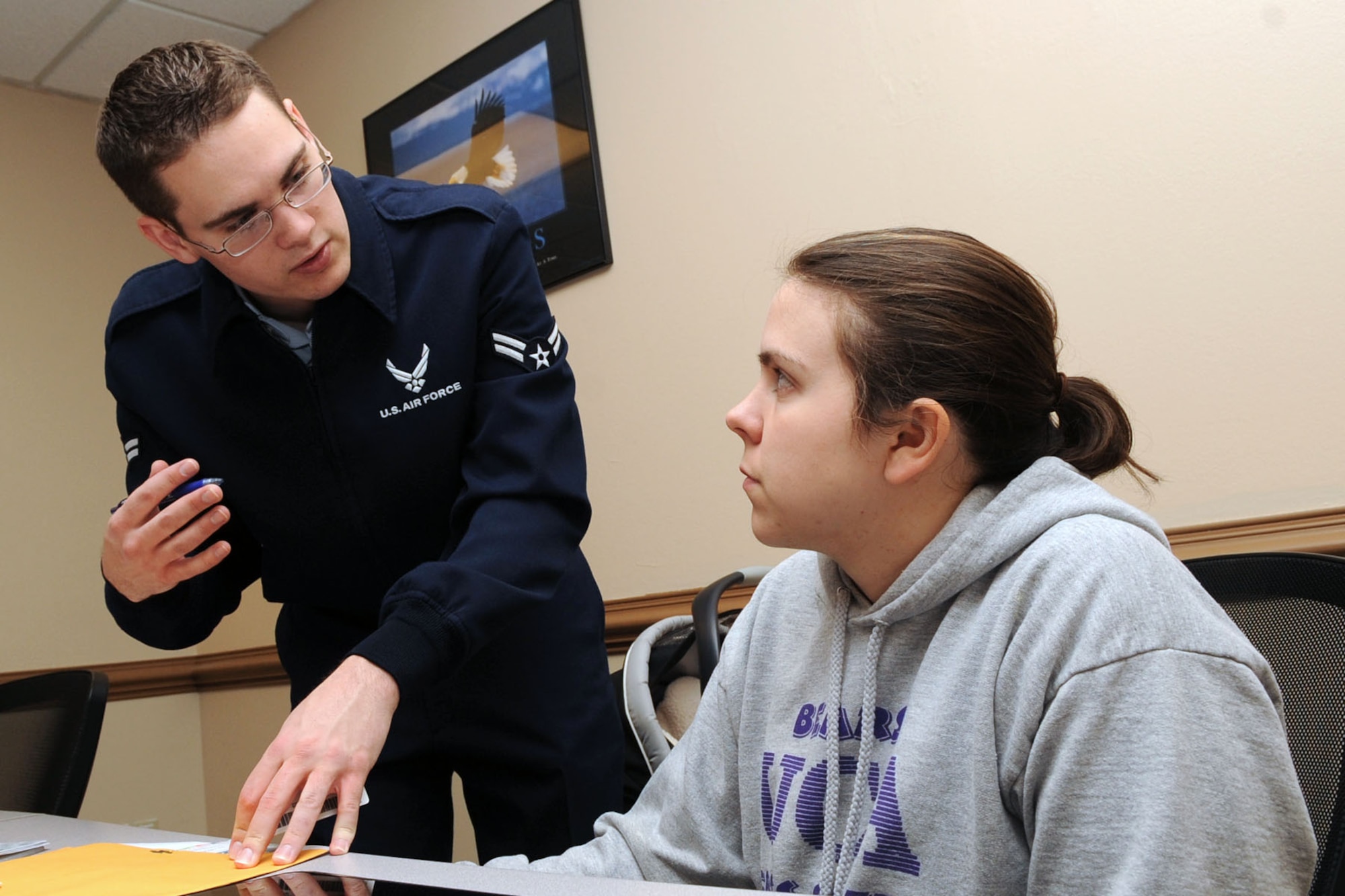 U. S. Air Force Airman 1st Class Andrew Neikirk, 633rd Comptroller Squadron travel technician, assists 1st. Lt. Rachel Hudman, 633rd Medical Group neonatal intensive care nurse, with adjusting her dependant-rate Basic Allowance for Housing at Langley Air Force Base Virginia, Jan. 10, 2012. The 633rd CPTS provides financial support for worldwide contingencies, and oversees non-appropriated funds and financial management. (U.S. Air Force photo by Staff Sgt. Jeff Nevison/Released)
