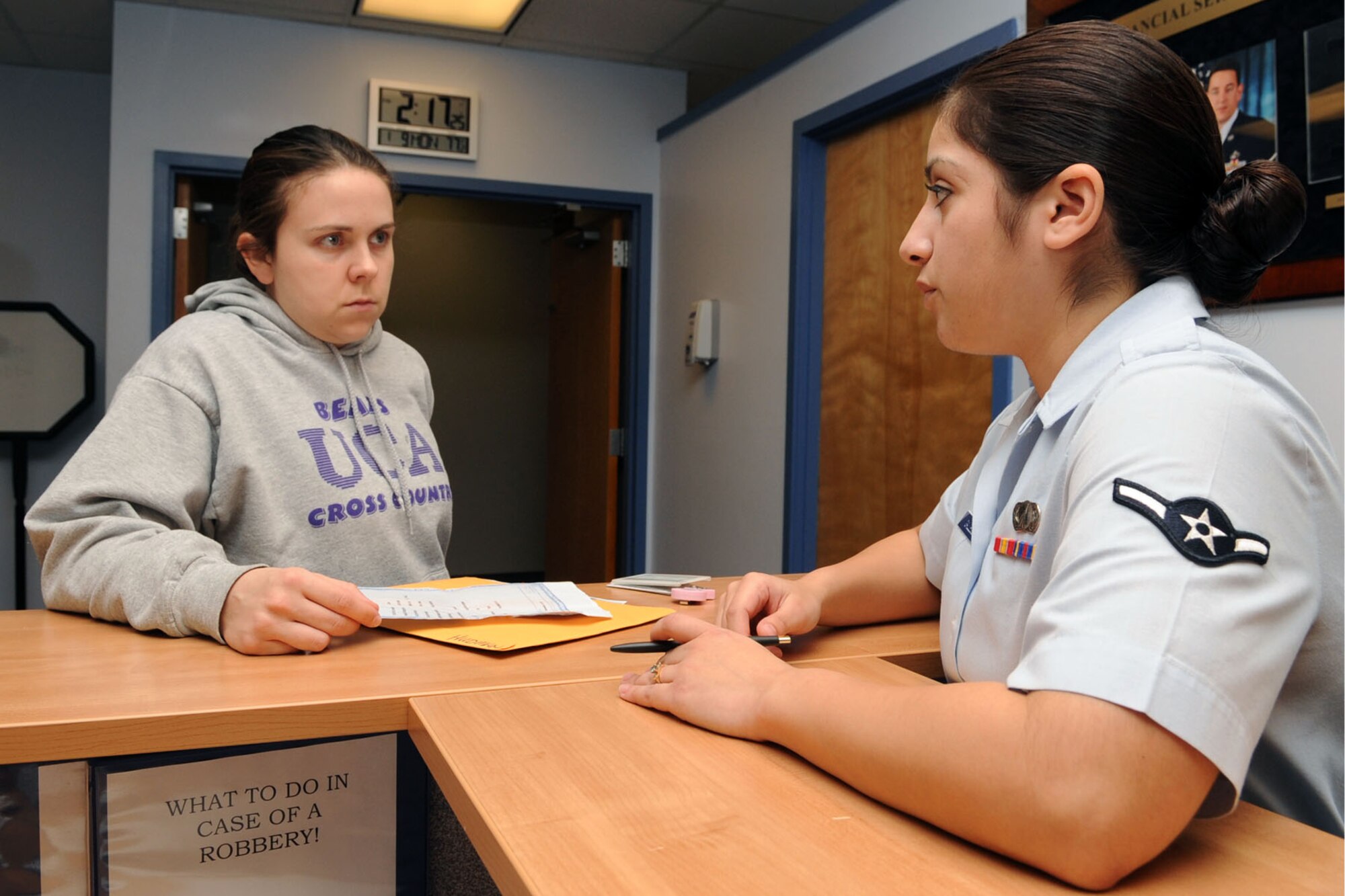 U. S. Air Force 1st. Lt. Rachel Hudman, 633rd Medical Group neonatal intensive care nurse, receives assistance in adjusting her dependant-rate Basic Allowance for Housing from Airman Grise Gallegos, 633rd Comptroller Squadron travel technician, at Langley Air Force Base Va., Jan. 10, 2012. The 633rd CPTS maintains and disburses payroll data for 10,815 military and civilian personnel from both Langley AFB and Fort Eustis. (U.S. Air Force photo by Staff Sgt. Jeff Nevison/Released)