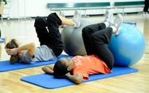 LAUGHLIN AIR FORCE BASE, Texas – Two participants go through a series of abdominal exercises during the third annual Aerobathon at the Losano Fitness Center here Jan. 14. The Aerobathon is an event designed to showcase the various aerobics classes offered at the gym for people to participate in. (U.S. Air Force photo/Airman 1st Class Nathan L. Maysonet)  