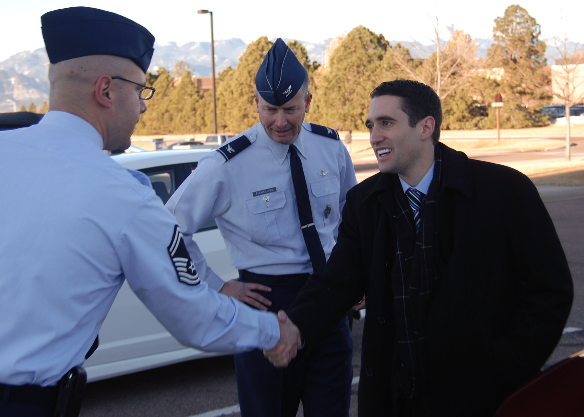 PETERSON AIR FORCE BASE, Colo. - Steve Kitay (right), professional staff member, House Armed Services Committee, is welcomed to the 21st Space Wing by Senior Master Sgt. John Bentivegna, 21st Operations Group chief enlisted manager (left), and Col. Jeffrey Flewelling, 21st SW deputy commander. Kitay was given an overview of the wing’s mission and a tour of the 76th and 16th Space Control Squadrons during his visit Jan. 10. (U.S. Air Force photo/Staff Sgt. Stacey Haga)
