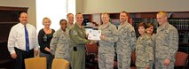 LAUGHLIN AIR FORCE BASE, Texas – Capt. James Steelman, 47th Flying Training Wing judge advocate, poses with Col. Tom Murphy, 47th Flying Training Wing commander, and Chief Master Sgt. Ray DeVite, 47th FTW command chief, after being presented the XLer of the week award here Jan. 4. The XLer is a weekly award chosen by wing leadership and given to those who consistently make outstanding contributions to Laughlin and their unit. (U.S. Air Force photo/Senior Airman Scott Saldukas)