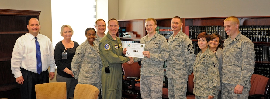LAUGHLIN AIR FORCE BASE, Texas – Capt. James Steelman, 47th Flying Training Wing judge advocate, poses with Col. Tom Murphy, 47th Flying Training Wing commander, and Chief Master Sgt. Ray DeVite, 47th FTW command chief, after being presented the XLer of the week award here Jan. 4. The XLer is a weekly award chosen by wing leadership and given to those who consistently make outstanding contributions to Laughlin and their unit. (U.S. Air Force photo/Senior Airman Scott Saldukas)