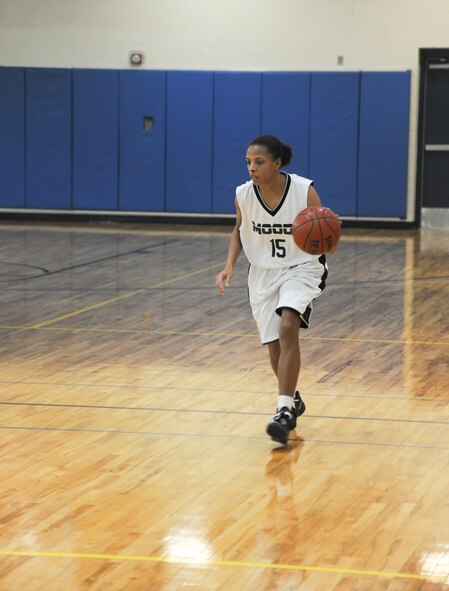 Ashley Searcy, Moody Air Force Base lady Flying Tigers basketball player, dribbles down the court during the second half of a varsity basketball game at Moody Air Force Base, Ga., Jan. 14, 2012. Searcy finished the game with 13 points as the Flying Tigers won the game against Warner Robins Air Force Base. (U.S. Air Force photo by Airman 1st Class Paul Francis/Released)
