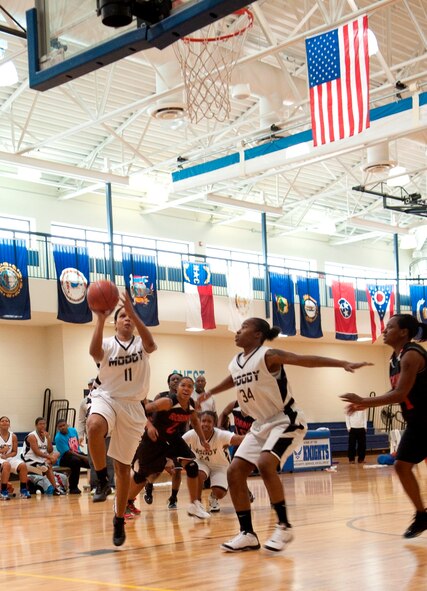 Stacy Williams, lady Flying Tigers shooting guard goes in for a layup scoring another two points for the lady Tigers. The lady Tigers varsity basketball team dominated the court at Moody Air Force Base, Ga., Jan. 14, 2012 and defeated Warner Robins Air Force base with a score of 75-66. (U.S. Air Force photo by Staff Sgt. Melissa K. Mekpongsatorn/Released)