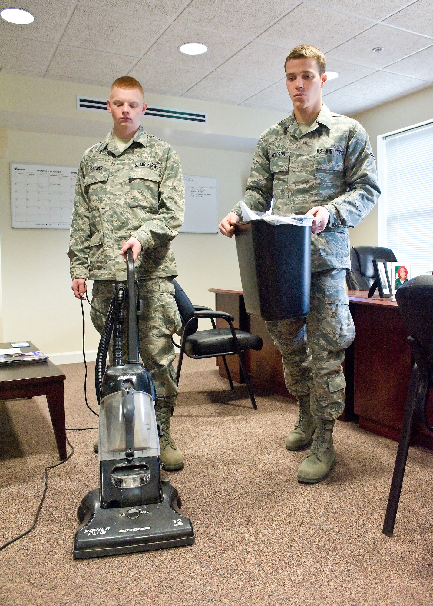 Airman Basic Anthony Palmer and Airman Leo Anderson, both assigned to Detachment 3, 373rd Training Squadron, perform bay orderly duties in the Dormitory Manager's office.  (U.S. Air Force photo by Roland Balik)