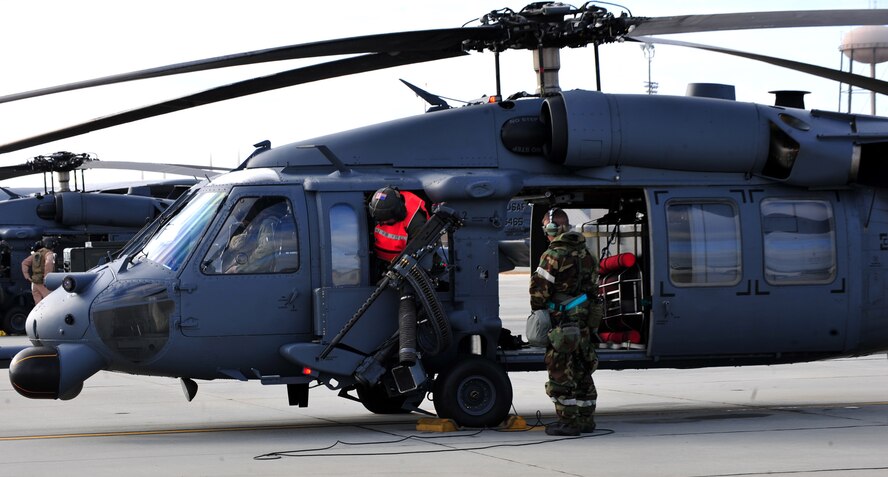 U.S. Air Force members with the 41st Rescue Squadron prepare for an HH-60G Pave Hawk flying mission during an operational readiness exercise at Moody Air Force Base, Ga., Jan. 11, 2012. The primary mission of the HH-60 is to conduct day or night personnel recovery operations into hostile environments to recover isolated personnel during war. (U.S. Air Force photo by Staff Sgt. Stephanie Mancha/Released) 