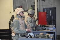 Staff Sgt. Adrianna Bsacochea-Gibbs and Master Sgt. Lila Barrino, Air Force Personnel Center, reload ammunition magazines during M-4 carbine qualification training Jan. 12. Training was held at the small arms range on Joint Base San Antonio-Randolph. (U.S. Air Force photo/Rich McFadden) (released)