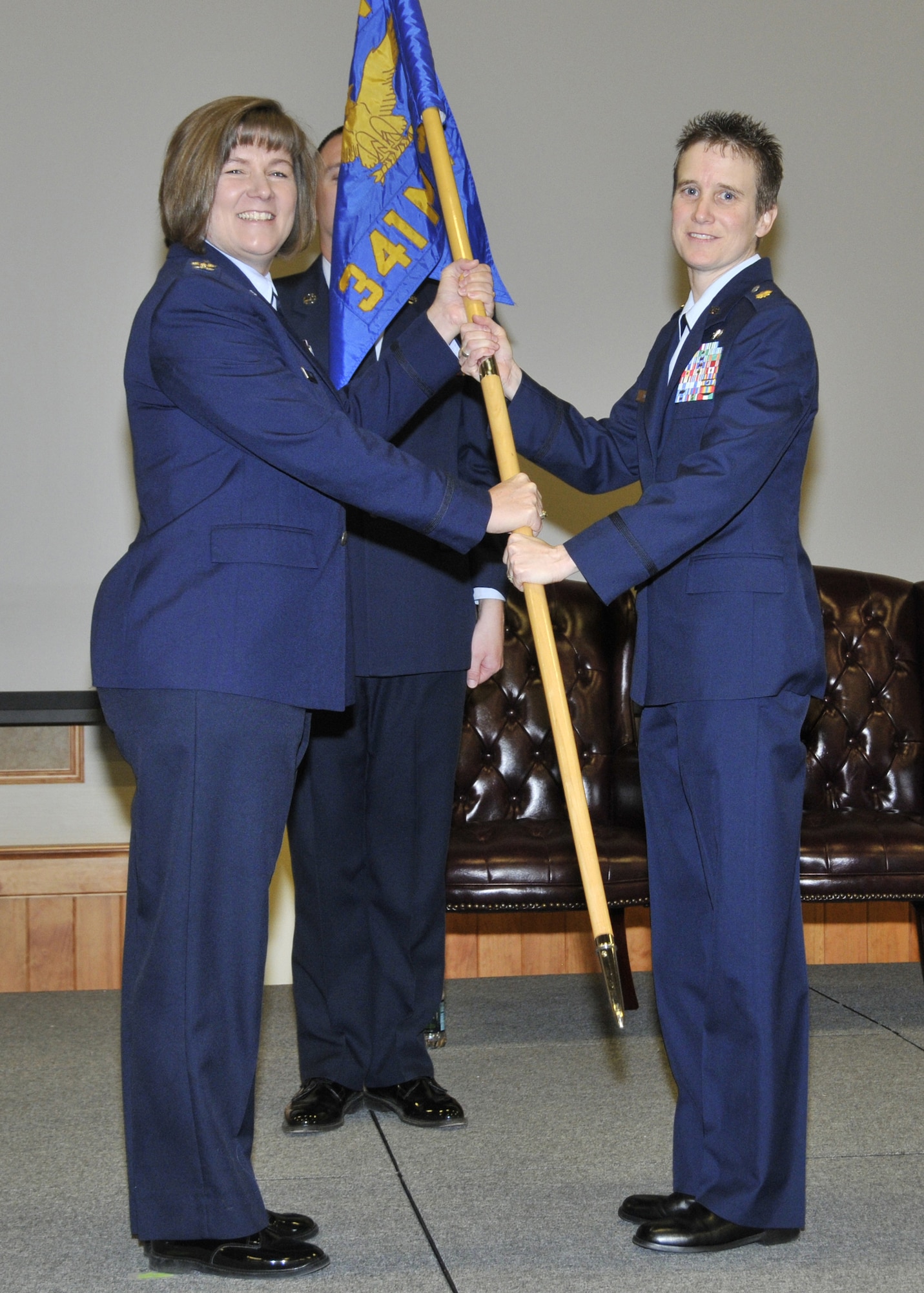Maj. Sabrina Jones accepts command of the 341st Force Support Squadron from Col. Angela Stout, 341st Mission Support Group commander, during a change of command ceremony Jan. 6 at the Grizzly Bend. Master Sgt. David Carr, 341st FSS first sergeant, looks on. (U.S. Air Force photo/John Turner)