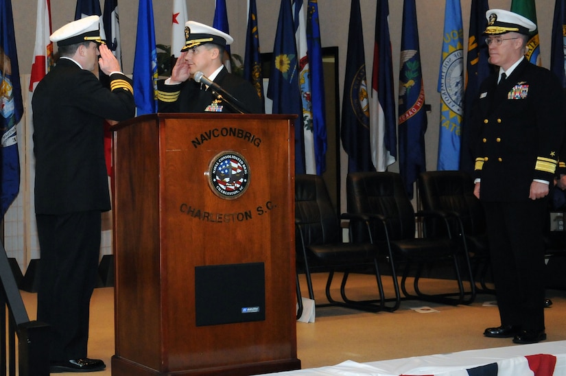 Rear Adm. Donald Quinn, right, watches as Cmdr. Chadwick Bryant, center, relieves Cmdr. Raymond Drake as the commanding officer of the Naval Consolidated Brig Charleston during a routine change of command ceremony at the Red Bank Club at Joint Base Charleston-Weapons Station Jan. 12. Quinn is the Navy Personnel Command commander and Deputy Chief of Naval Personnel. (U.S. Navy photo/Petty Officer 2nd Class Brannon Deugan)