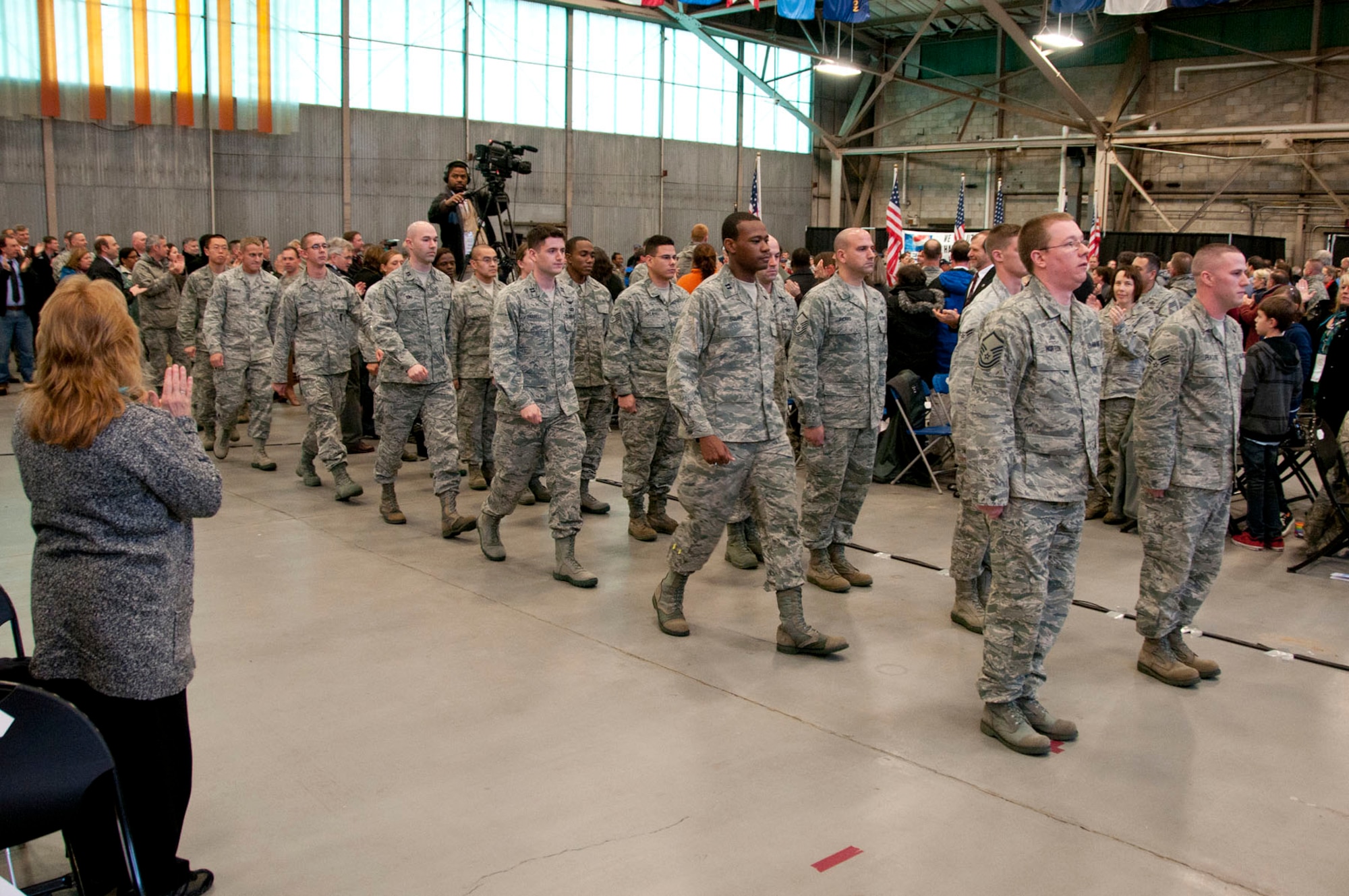 HANSCOM AIR FORCE BASE, Mass. – Airmen march into the Aero Club Hangar during a homecoming celebration on Jan. 12. Fifty-four members of Hanscom Air Force Base who recently returned from deployments during the past six months were honored along with their families during the Heroes Homecoming event. (U.S. Air Force photo by Mark Wyatt)