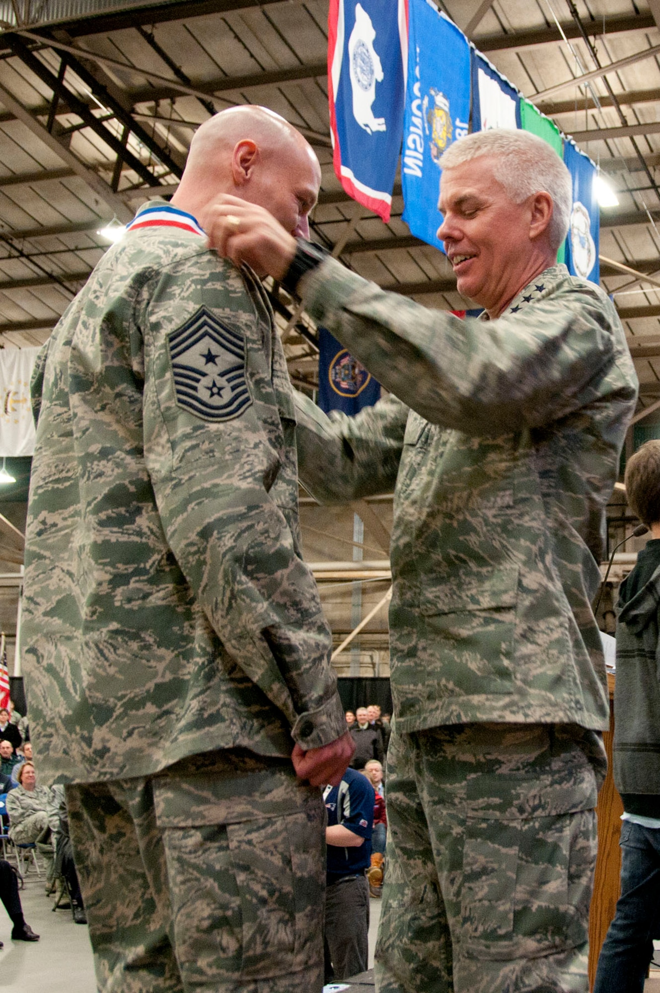 HANSCOM AIR FORCE BASE, Mass. -- Lt. Gen. CR Davis, Electronic Systems Center commander, places a medallion around the neck of Chief Master Sgt. Kevin L. Call, ESC command chief, during a homecoming celebration Jan. 12. Chief Call was among 54 personnel assigned to the base that have returned from deployments during the past six months and were honored along with their families during the Heroes Homecoming event. (U.S. Air Force photo by Mark Wyatt)