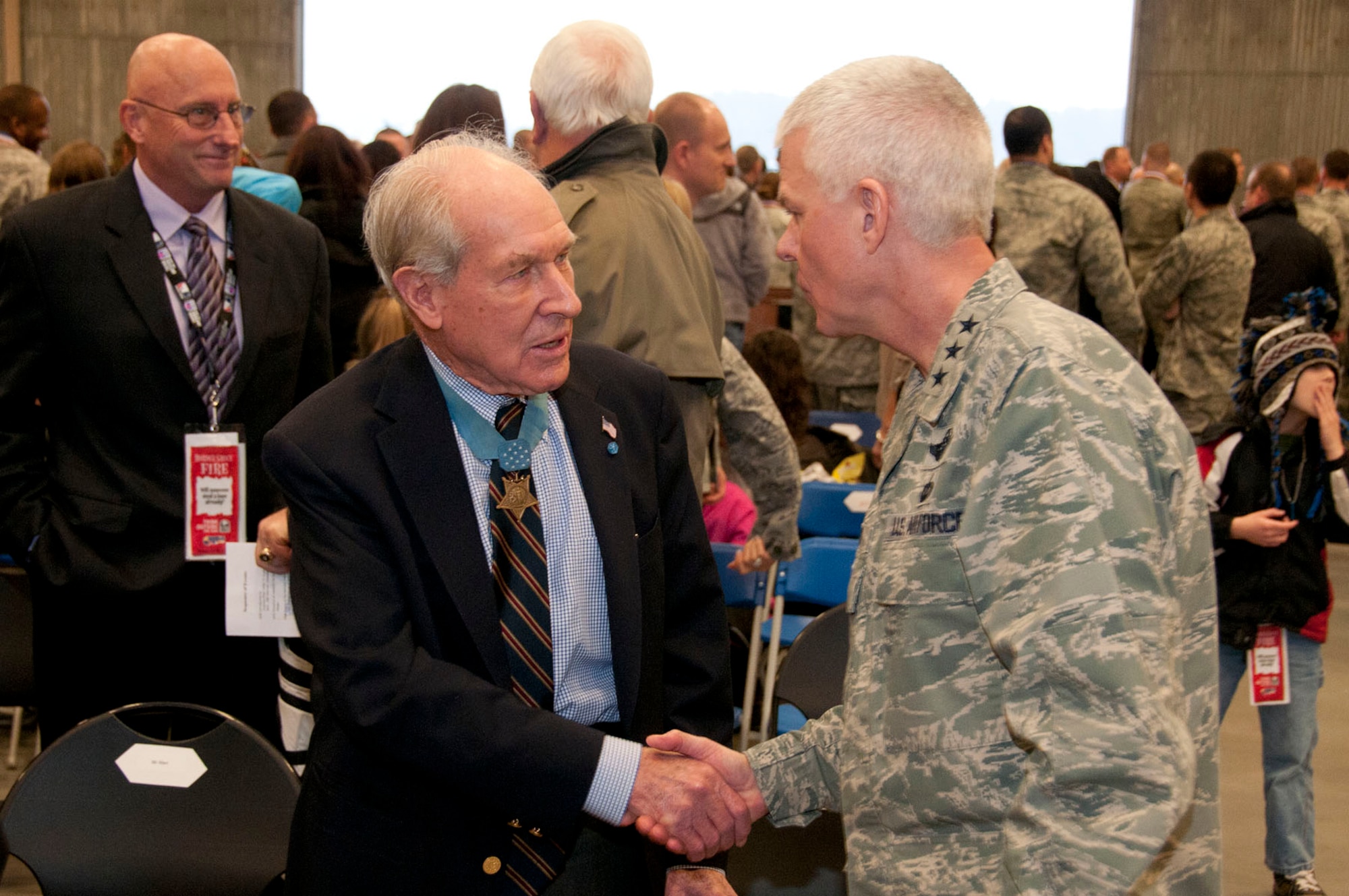 HANSCOM AIR FORCE BASE, Mass. -- Lt. Gen. CR Davis, Electronic Systems Center commander, shakes hands with Medal of Honor recipient Navy Capt. Tom Hudner at a homecoming celebration Jan. 12. The Heroes Homecoming event welcomed home 54 Airmen that are assigned to the base and have returned home from deployments during the past six months. (U.S. Air Force photo by Mark Wyatt)