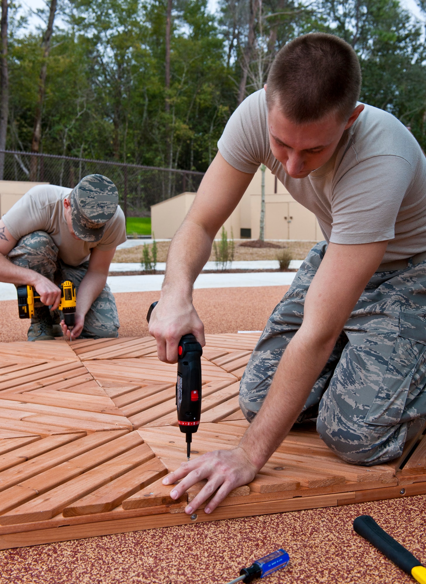 (Left to right) Senior Airman Jacob McGlothlin and Airman 1st Class Thomas Howard, of Eglin Honor Guard members, build a base for a playhouse at the new Child Development Center, Jan. 10 at Eglin Air Force Base, Fla.  The new CDC had a ribbon cutting Jan. 13, here.  The $11 million project was funded through the Base Realignment and Closure based on the scheduled relocation of families from the 7th Special Forces Group and the arrival of the joint strike fighter in 2011.  The CDC will open for child care Jan. 17.  When all the CDC facilities open, they will care for 744 children on a daily basis.  (U.S. Air Force photo/Samuel King Jr.)