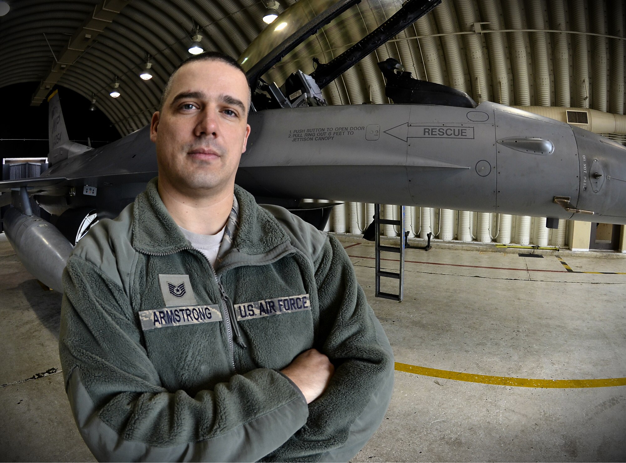 Tech. Sgt. Barry Armstrong, an 8th Maintenance Group weapons quality assurance inspector, poses for a portrait with an F-16 Fighting Falcon at Kunsan Air Base, South Korea, Jan. 17, 2012. Armstrong shares his more than 14 years of experience working as a weapons loader in the Air Force and what it took to get where he is. (U.S. Air Force photo/Senior Airman Benjamin Stratton/)