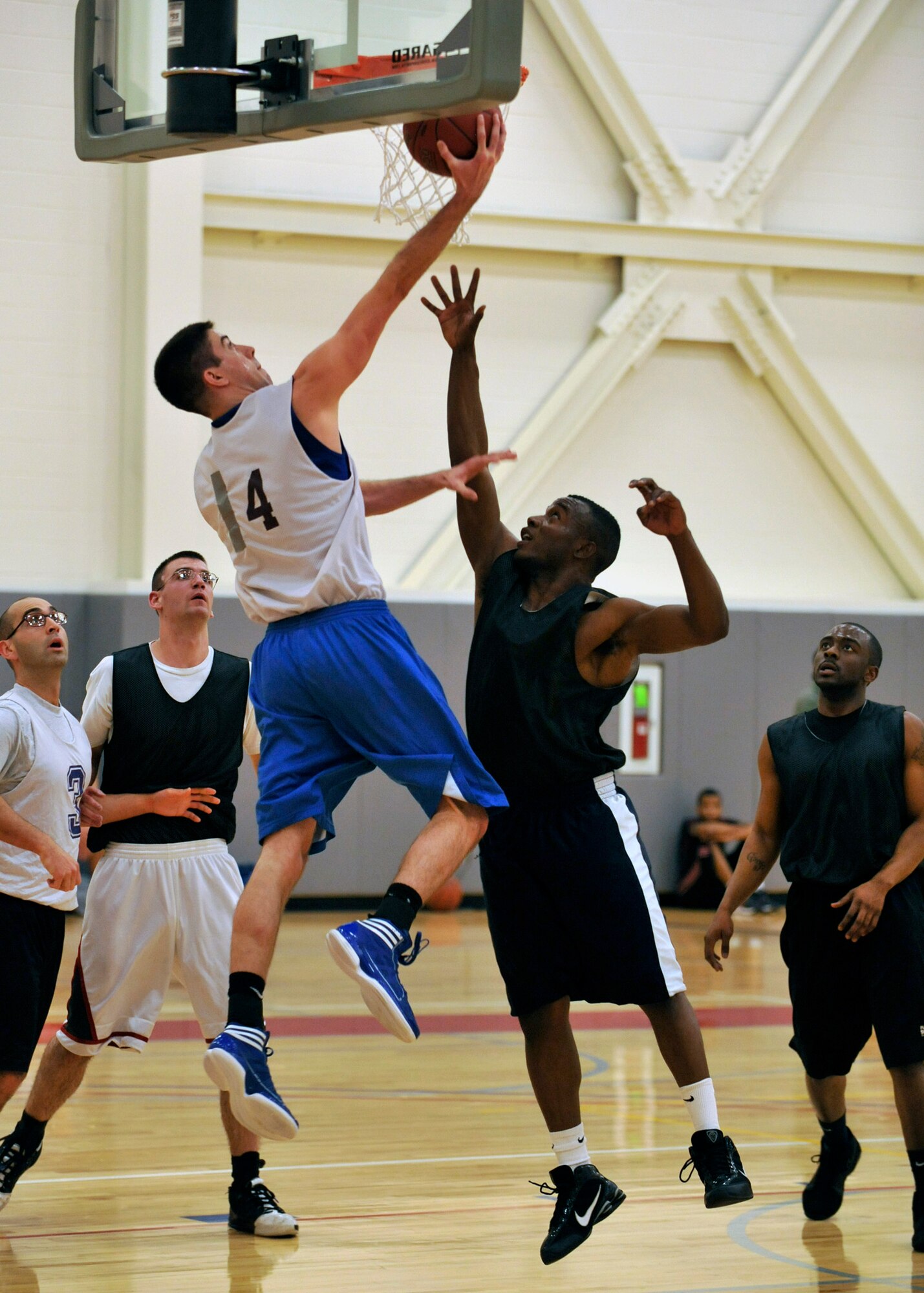 Hunter Myers, player-coach for the 436th Communications Squadron, goes up for a reverse layup against the 436th Logistics Readiness Squadron in an intramural basketball game at the base fitness center Jan. 12, 2012, Dover Air Force Base, Del. Myers scored a game-high 22 points as he led 436th CS to a 47-32 victory. (U.S. Air Force photo by Tech. Sgt. Chuck Walker)