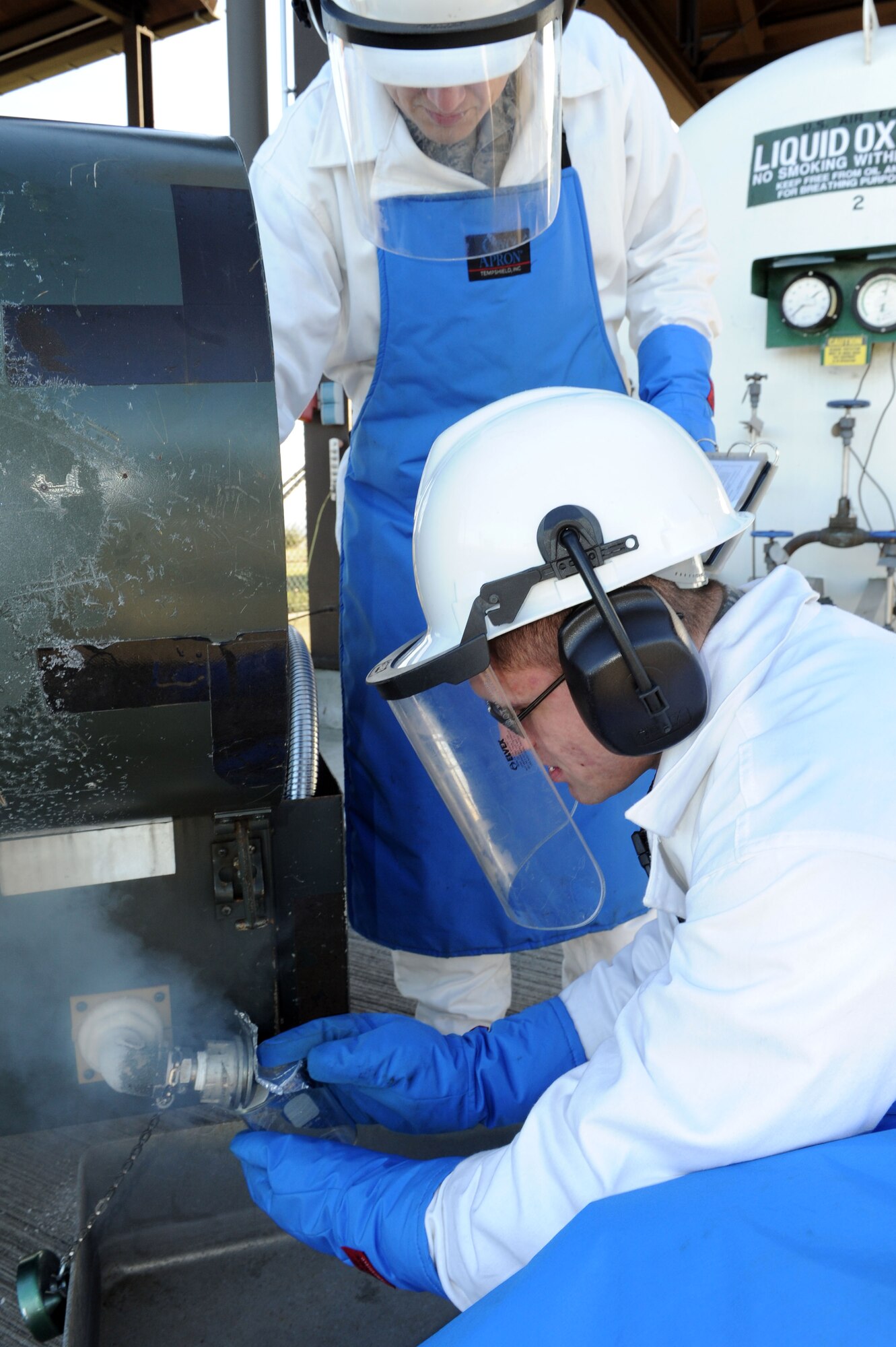 SPANGDAHLEM AIR BASE, Germany – Airman 1st Class Kyle Coates, 52nd Logistics Readiness Squadron hydrant operator, and Staff Sgt. Celso Velez, NCO in charge of cryogenics, receives an odor sample of liquid oxygen during a daily inspection here Jan. 17. A quality check of odor of the liquid oxygen is done for every daily issue to make sure the oxygen is breathable. The cryogenics shop supports the cargo planes with oxygen ensuring the planes are mission ready. (U.S. Air Force photo / Senior Airman Christopher Toon)