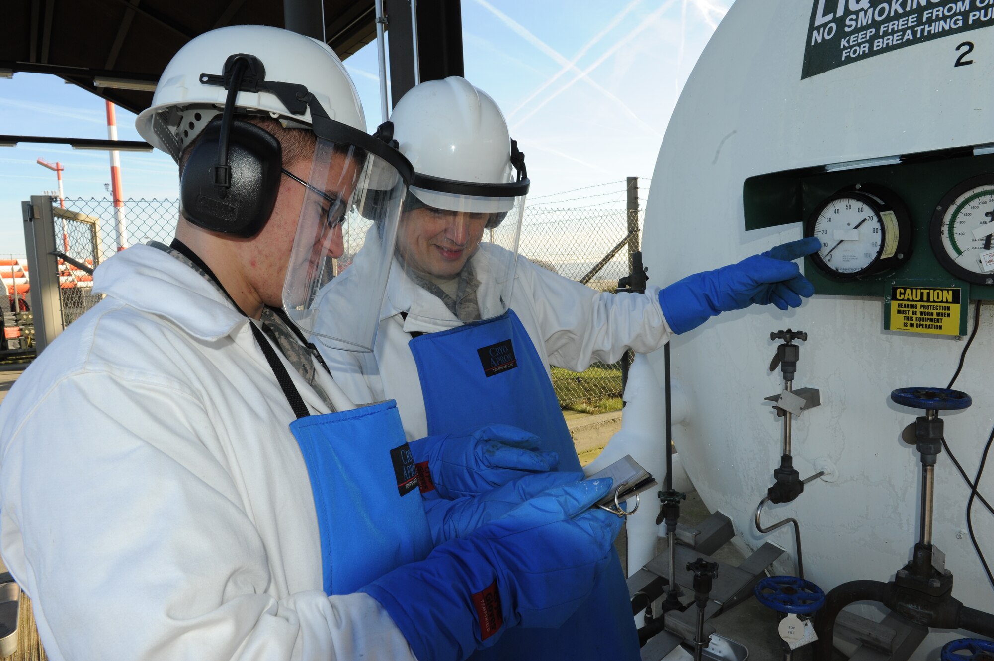 SPANGDAHLEM AIR BASE, Germany – Airman 1st Class Kyle Coates, 52nd Logistics Readiness Squadron hydrant operator, and Staff Sgt. Celso Velez, NCO in charge of cryogenics, observe the pressure gauge of a liquid oxygen tank during a daily issuing of LOX here Jan. 17. The cryogenics shop supports the cargo planes with oxygen ensuring the planes are mission ready. (U.S. Air Force photo / Senior Airman Christopher Toon)