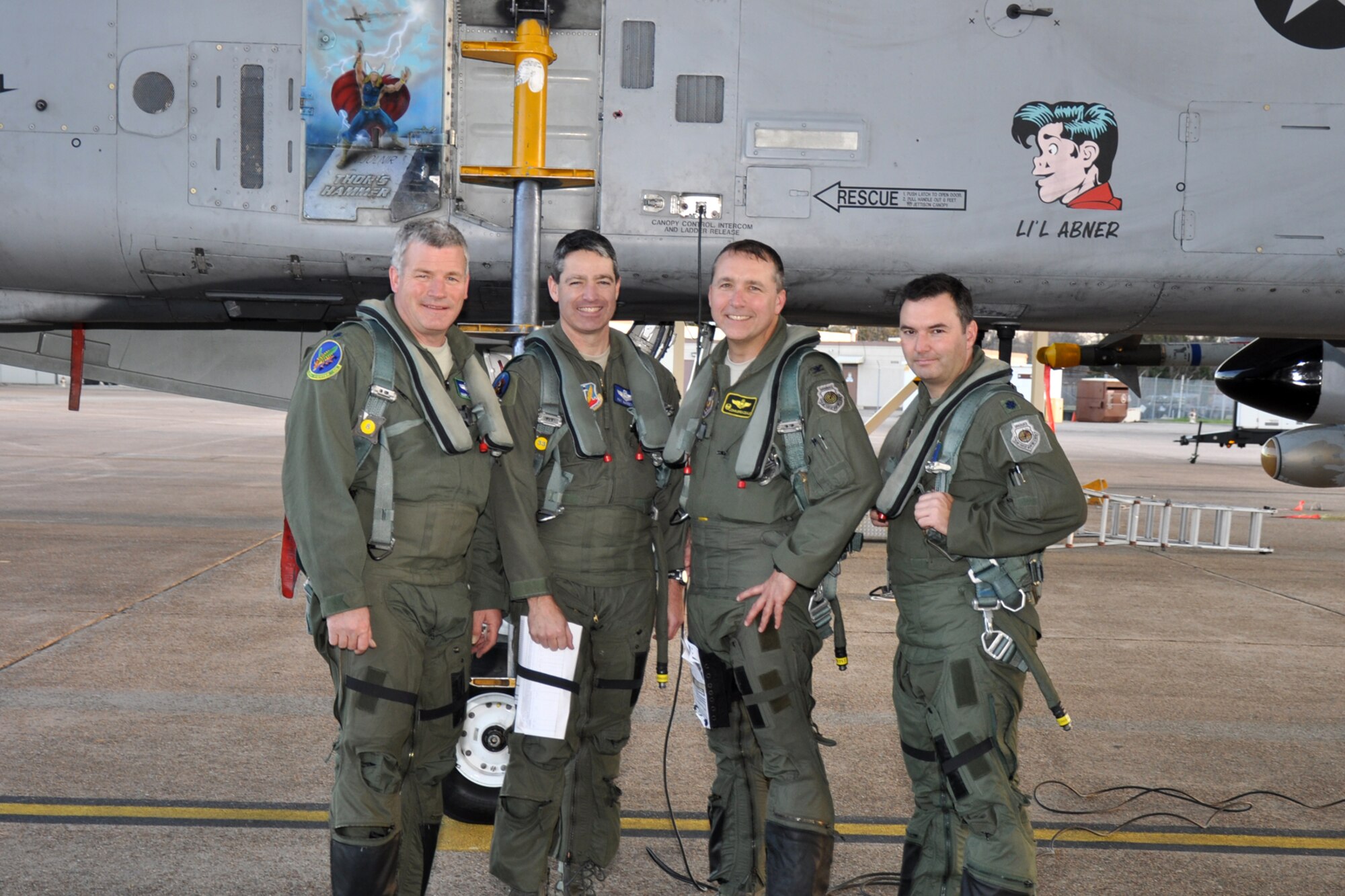 Lt. Cols. Marc Olson and Patrick McKeever, both A-10 pilots assigned to the 47th Fighter Squadron, Col. John Breazeale, commander of the 917th Fighter Group, and Lt. Col. Robert Hetland, weapons officer for the 47th FS, strike their “Warrior” pose after returning from a four-ship sortie at Barksdale Air Force Base, La., Jan. 11, 2012. That sortie pushed Olson over the 5,000 flying hours mark in an A-10 Thunderbolt II. (U.S. Air Force photo by Master Sgt. Jeff Walston/Released)