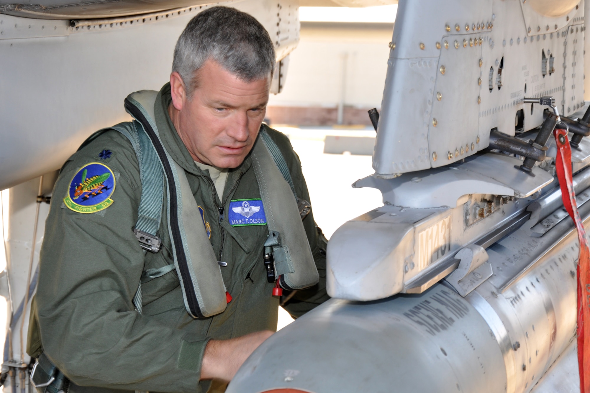 Lt. Col. Marc Olson, an A-10 pilot assigned to the 47th Fighter Squadron, performs a pre-flight inspection of an A-10 Thunderbolt II before a flight at Barksdale Air Force Base, La., Jan. 11, 2012. (U.S. Air Force photo by Master Sgt. Jeff Walston/Released) 