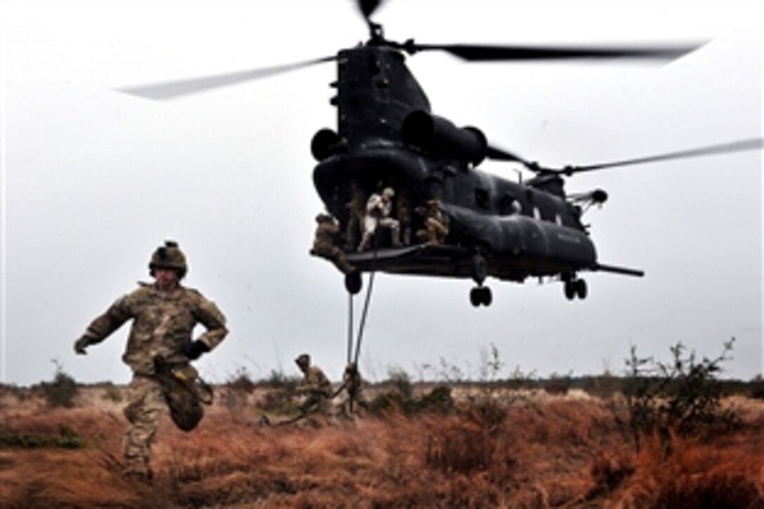 Rangers rappel out the back of a CH-47 Chinook helicopter while participating in a combined arms live-fire exercise near Fort Stewart, Ga., Jan. 10, 2012. The Rangers are assigned to the 1st Battalion, 75th Ranger Regiment. The exercise is conducted to evaluate and train members on de-escalation of force, reactions to enemy contact, and other objectives that prepare them for forward operations.