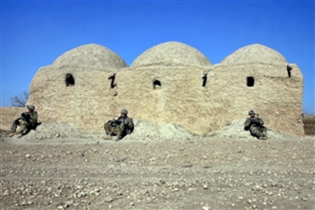 U.S. soldiers lean against a mud wall during a break from combat operations in Kandahar province's southern Spin Boldak district in Afghanistan, Jan. 9, 2012. The soldiers are assigned to the 504th Battlefield Brigade's 38th Cavalry Regiment, 2nd Squadron.