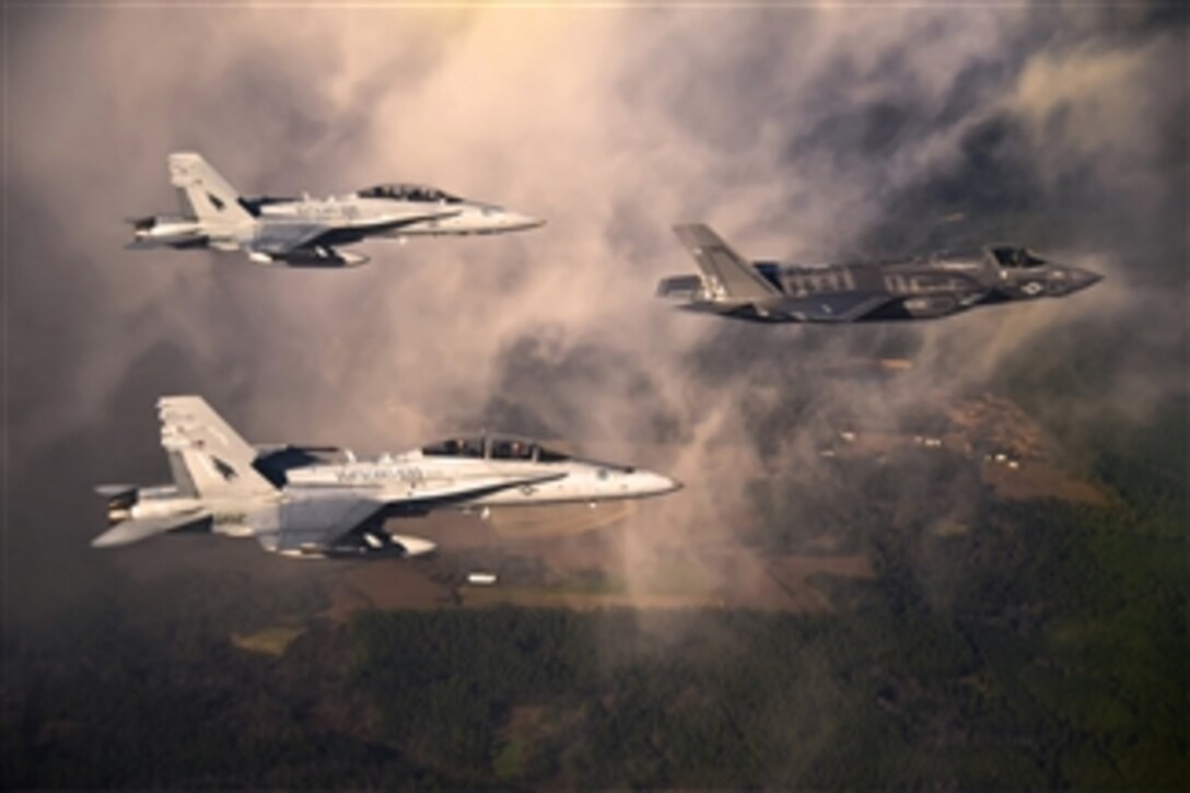 A U.S. Marine Corps F-35 Lightening II aircraft is escorted by two Marine F/A-18 Hornets as it flies toward Eglin Air Force Base, Fla., on Jan. 11, 2012.  The Marine Fighter Attack Training Squadron 501 received two F-35s.  