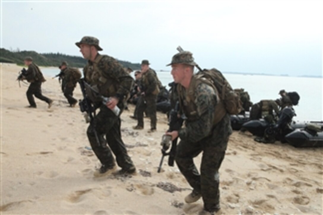 Marines with Company A, Battalion Landing Team 1st Battalion, 4th Marines, 31st Marine Expeditionary Unit, run up the Kin Blue training area beach after leaving their combat rubber raiding craft during a mock boat raid in Okinawa, Japan, on Jan. 13, 2012.  The main objective of the boat raid exercise was to eliminate any hostile presence in the Kin Blue town and to secure the surrounding area.  